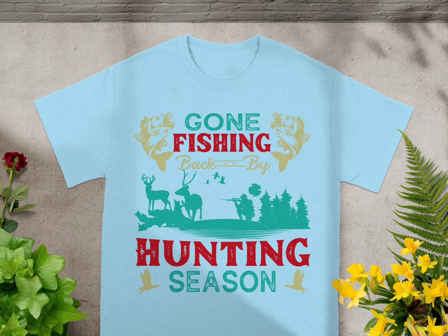 Light blue t-shirt with "Gone Fishing Back By Hunting Season" text and wildlife graphic.