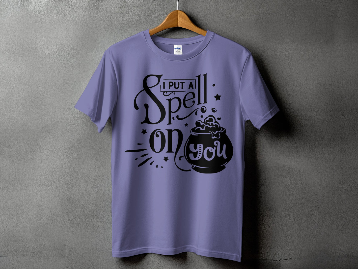 Lavender t-shirt with "I PUT A Spell ON you" and cauldron graphic