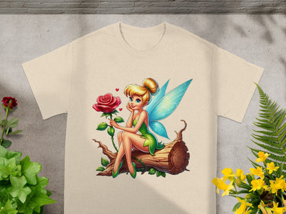 Tinkerbell with a rose sitting on a log, on a cream t-shirt.