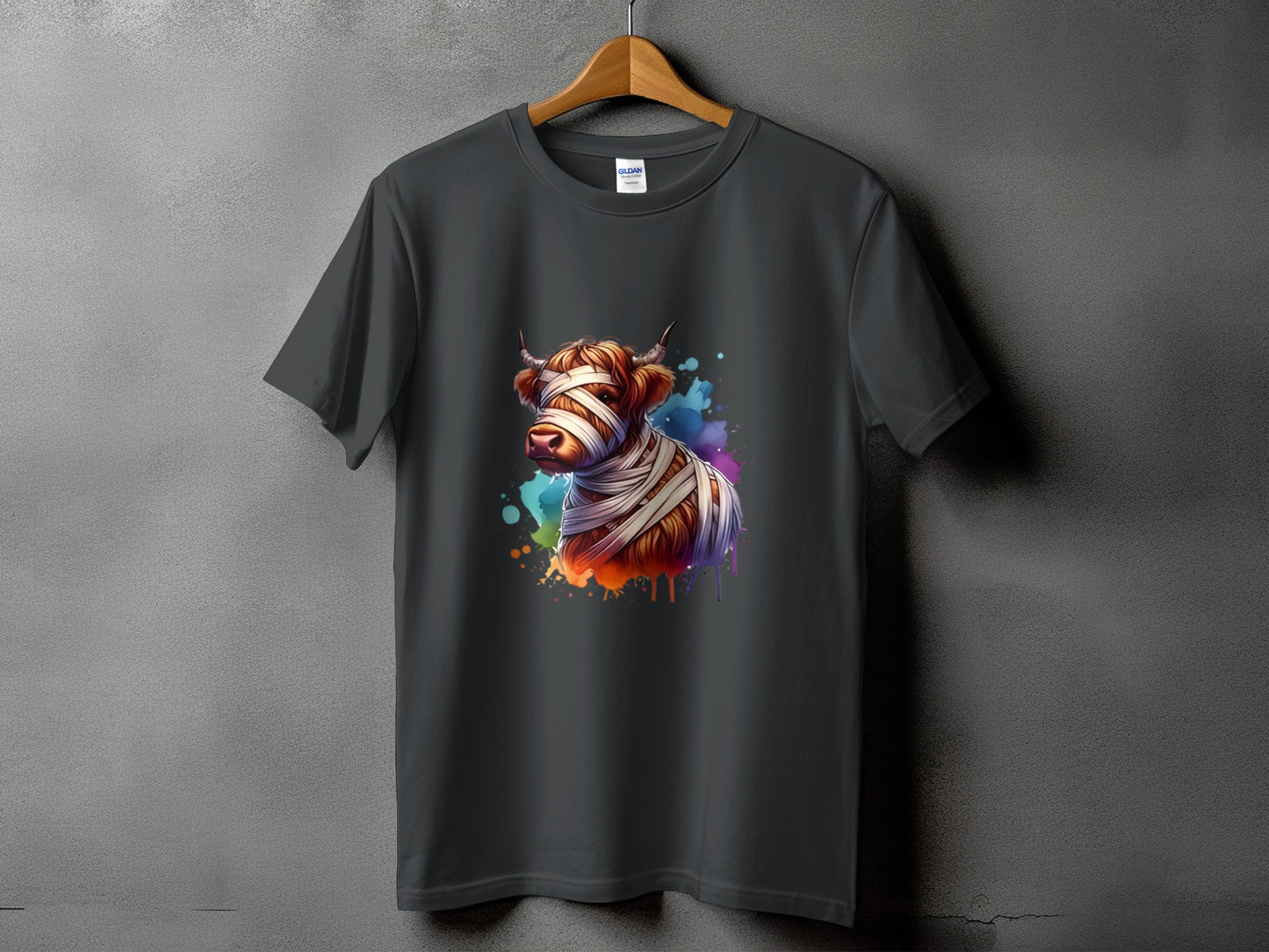 Dark gray t-shirt with a watercolor Highland cow graphic wrapped in bandages.
