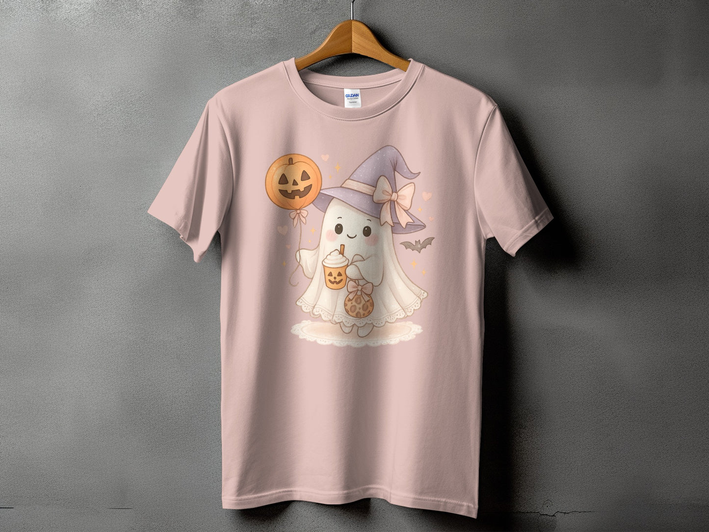 Pink t-shirt with cute ghost in witch hat holding pumpkin drink and cookie.