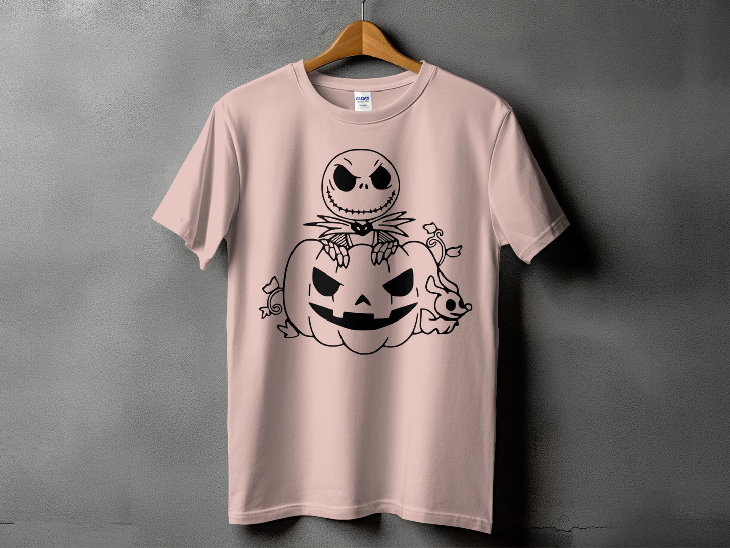 Pink t-shirt with black graphic of Jack Skellington sitting on a pumpkin.