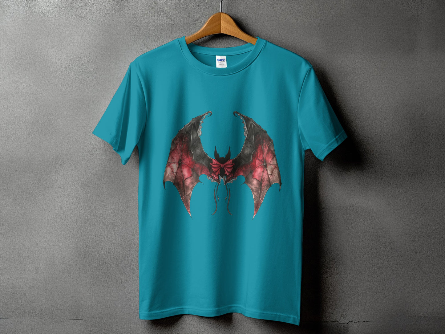 Teal t-shirt with a graphic of large, detailed bat wings with a red bow.
