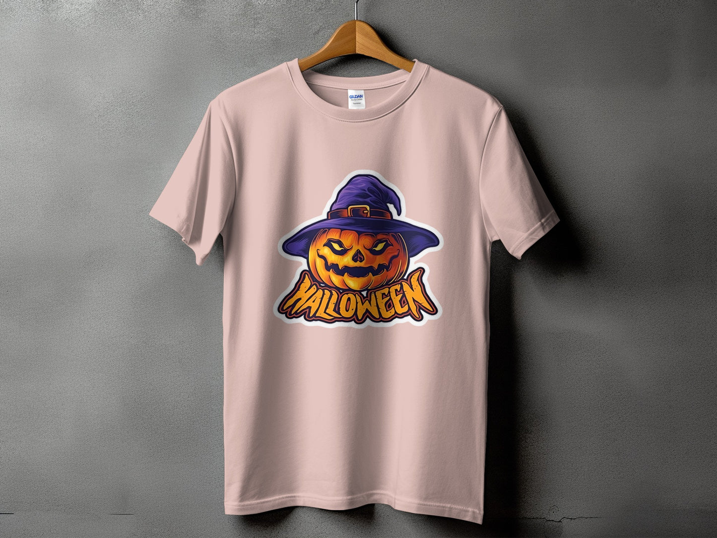 Pink t-shirt with a jack-o'-lantern wearing a witch hat and "Halloween" text.
