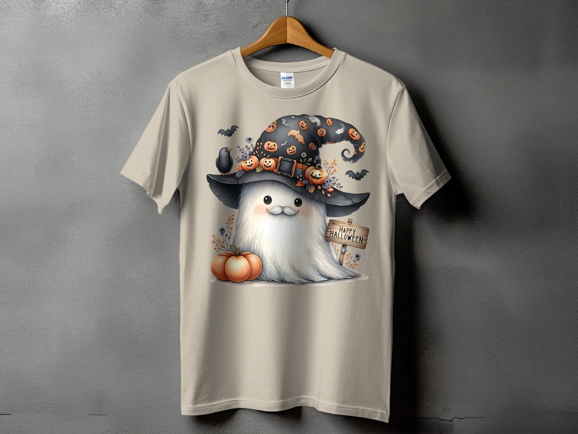 Ghost with witch hat, pumpkins, bats, and "Happy Halloween" sign on a t-shirt.