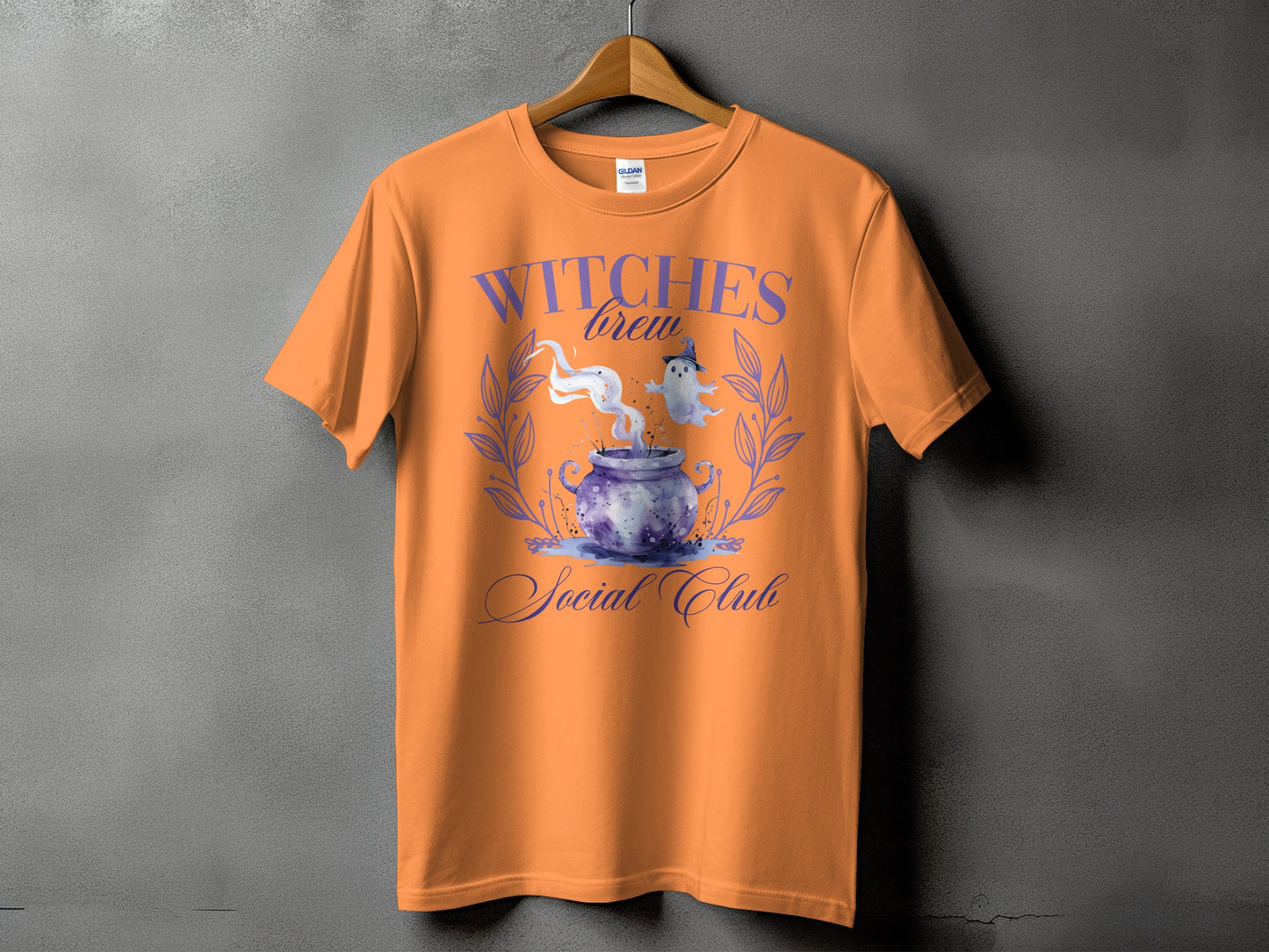 Orange t-shirt with "Witches Brew Social Club" text and Halloween graphic.