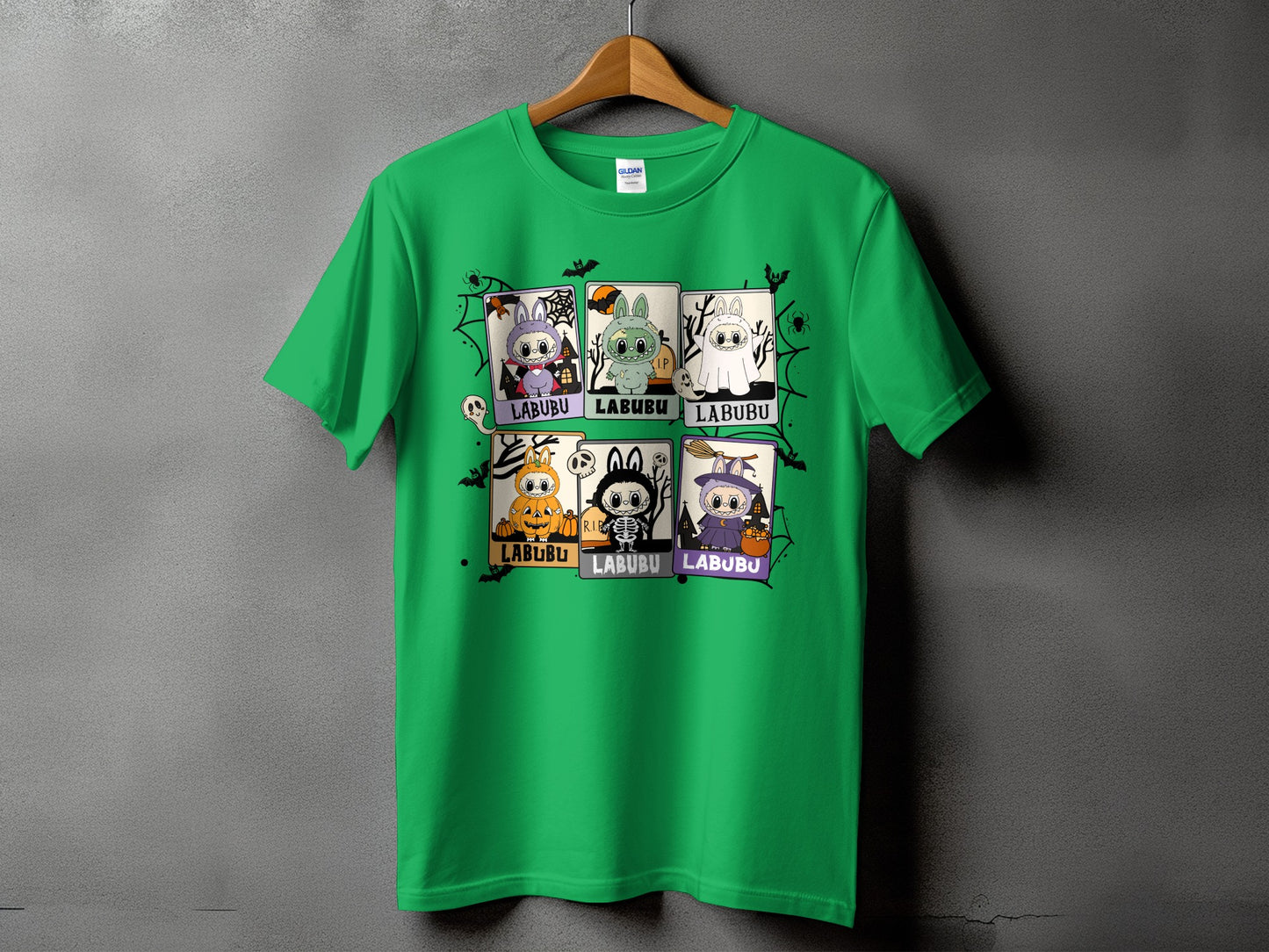Green t-shirt with six cartoon characters in Halloween costumes and the text LABUBU.