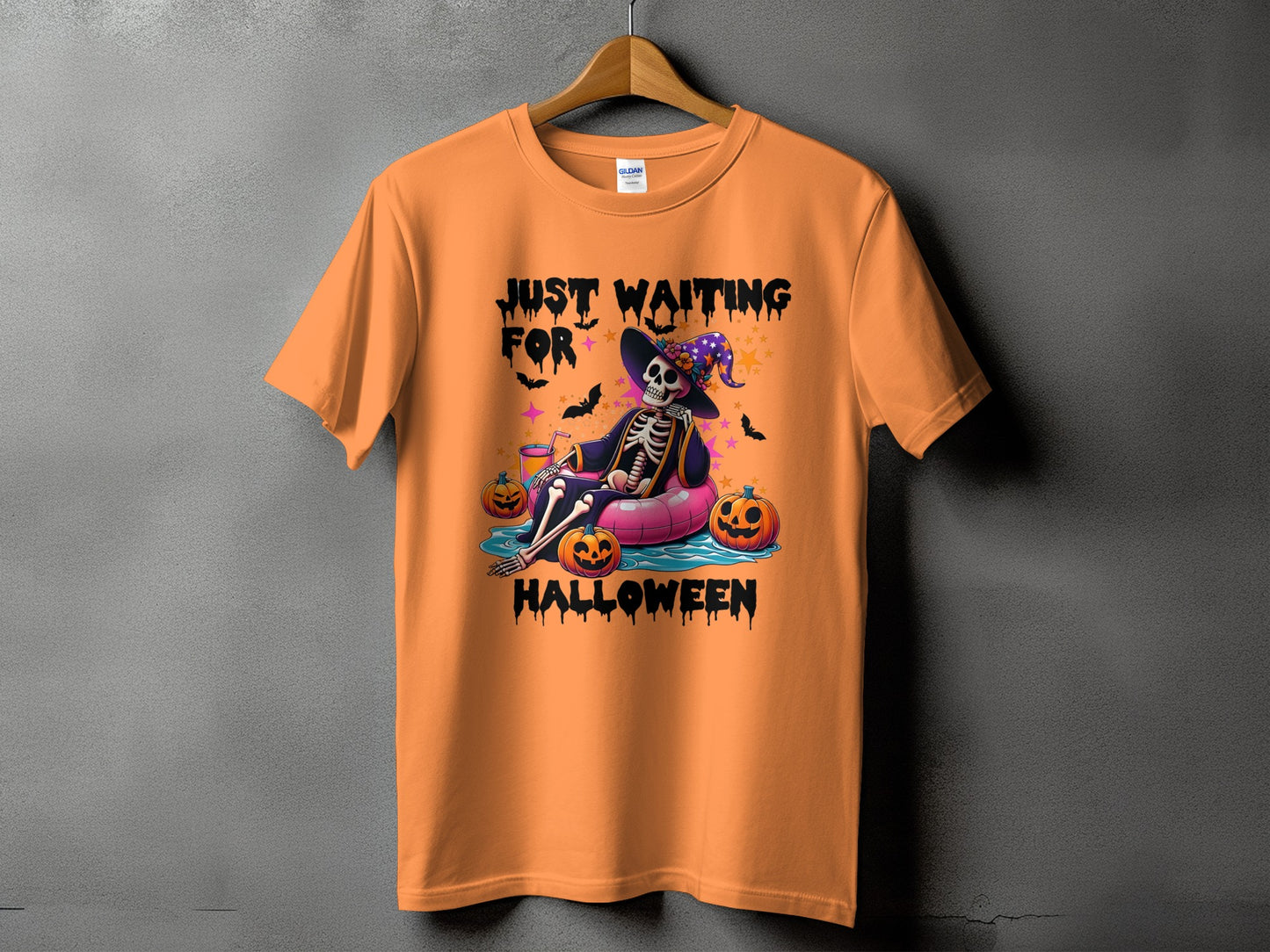 Orange t-shirt with "Just Waiting For Halloween" text and a skeleton wearing a witch hat.