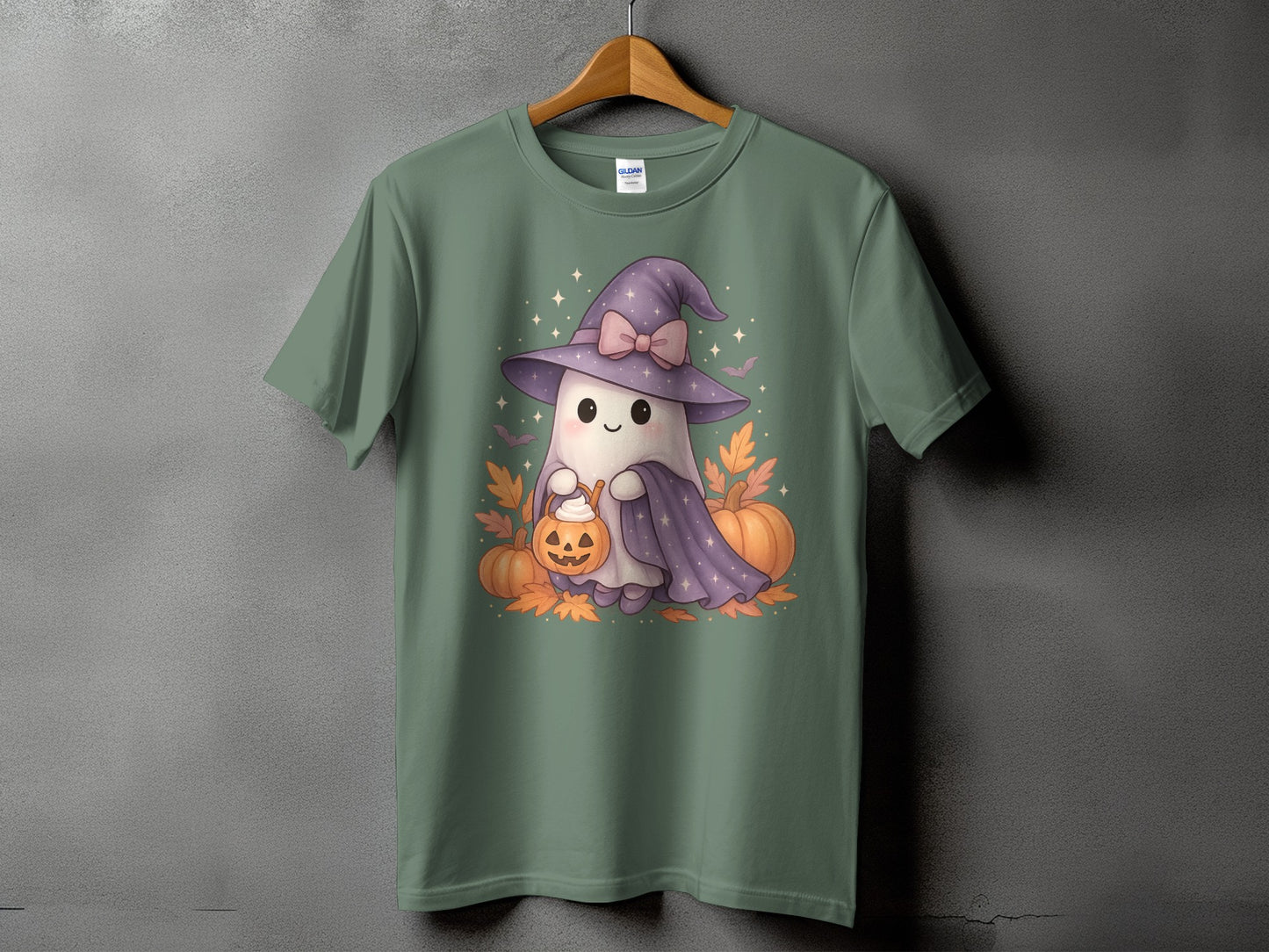 Cute ghost wearing a witch hat holding a pumpkin bucket with autumn leaves and pumpkins.