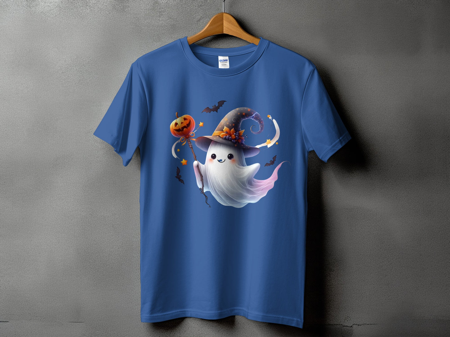 Blue t-shirt with a cute ghost character in a witch hat holding a pumpkin wand.