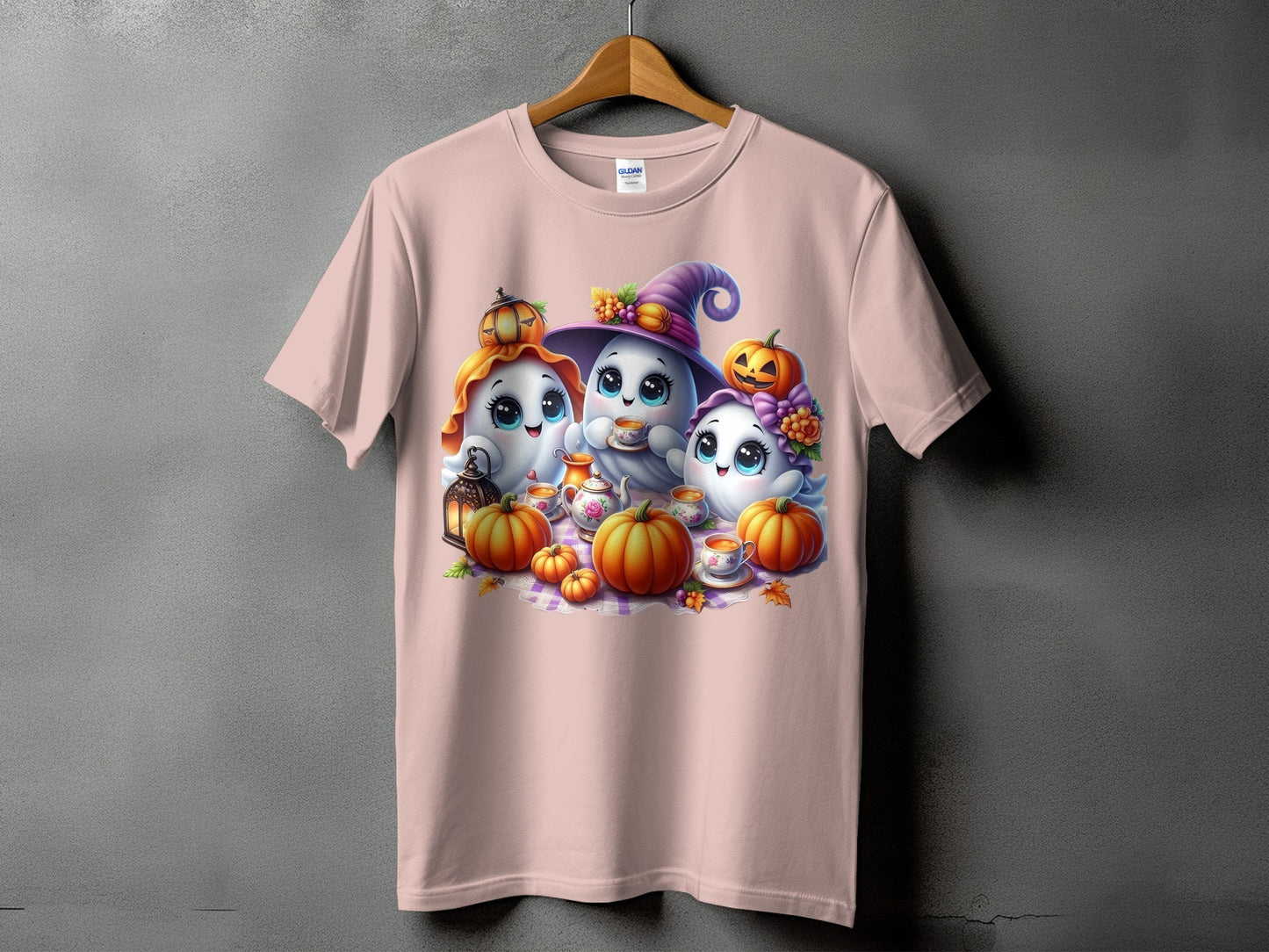 Three cute ghosts with pumpkins and a teapot on a pink t-shirt.