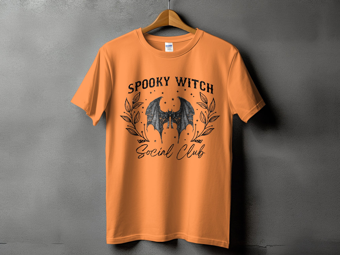 Orange t-shirt with "Spooky Witch Social Club" text and bat graphic.