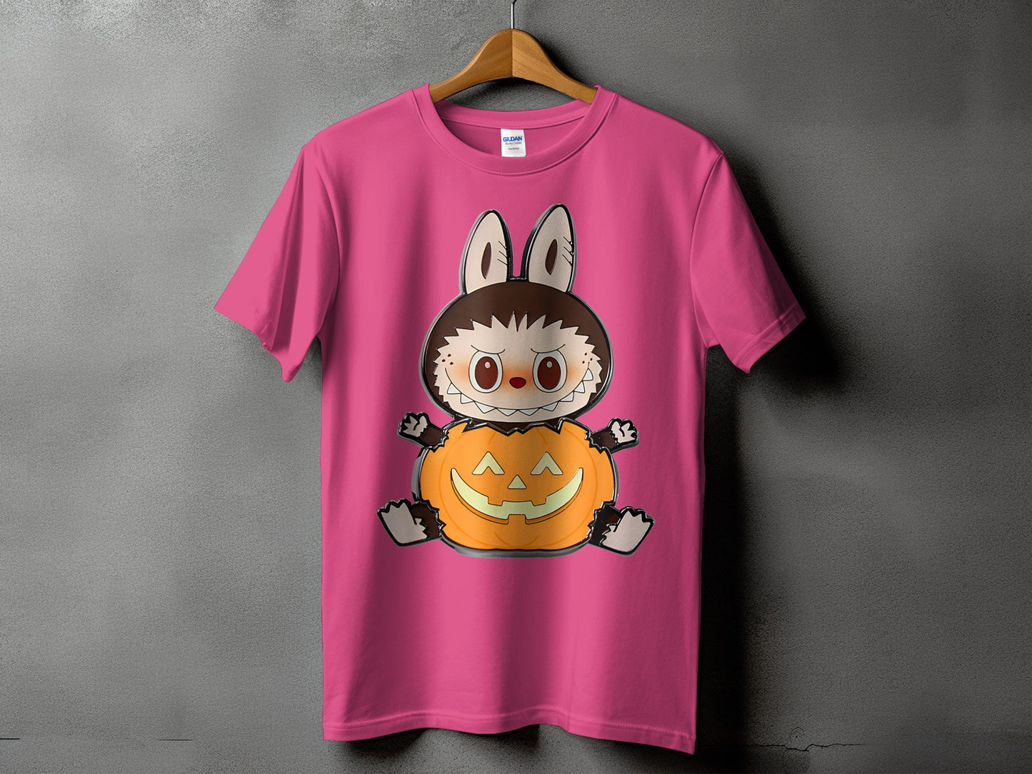 Pink t-shirt with cartoon character sitting in a jack-o'-lantern.