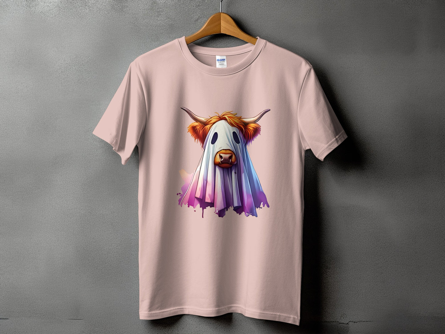Pink t-shirt with a Highland cow dressed as a ghost with horns.