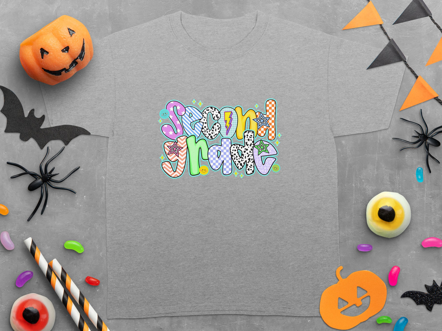 Gray t-shirt with "Second Grade" in colorful, patterned text and Halloween decorations.