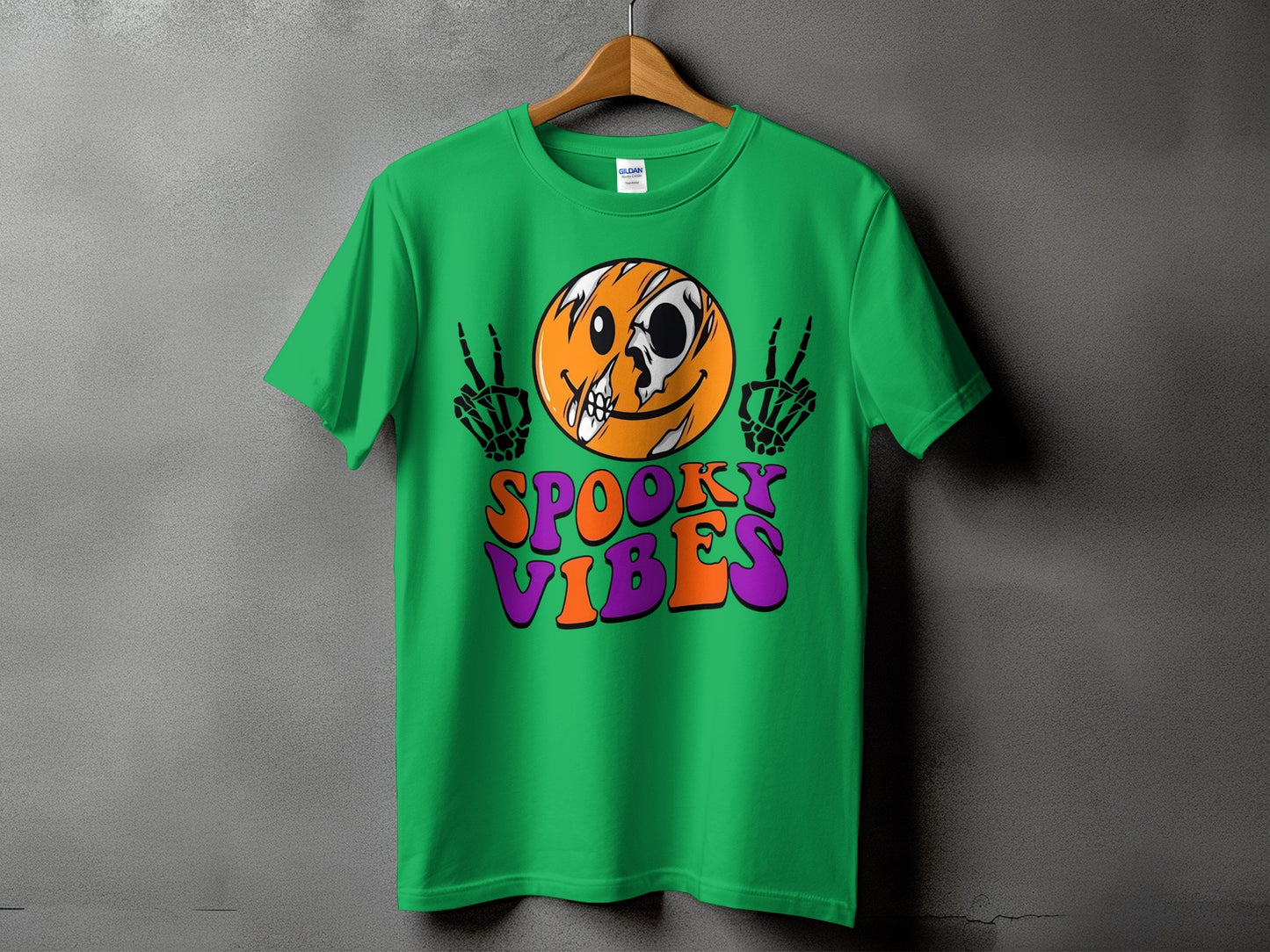 Green t-shirt with skull emoji, skeleton hands, and "Spooky Vibes" text.