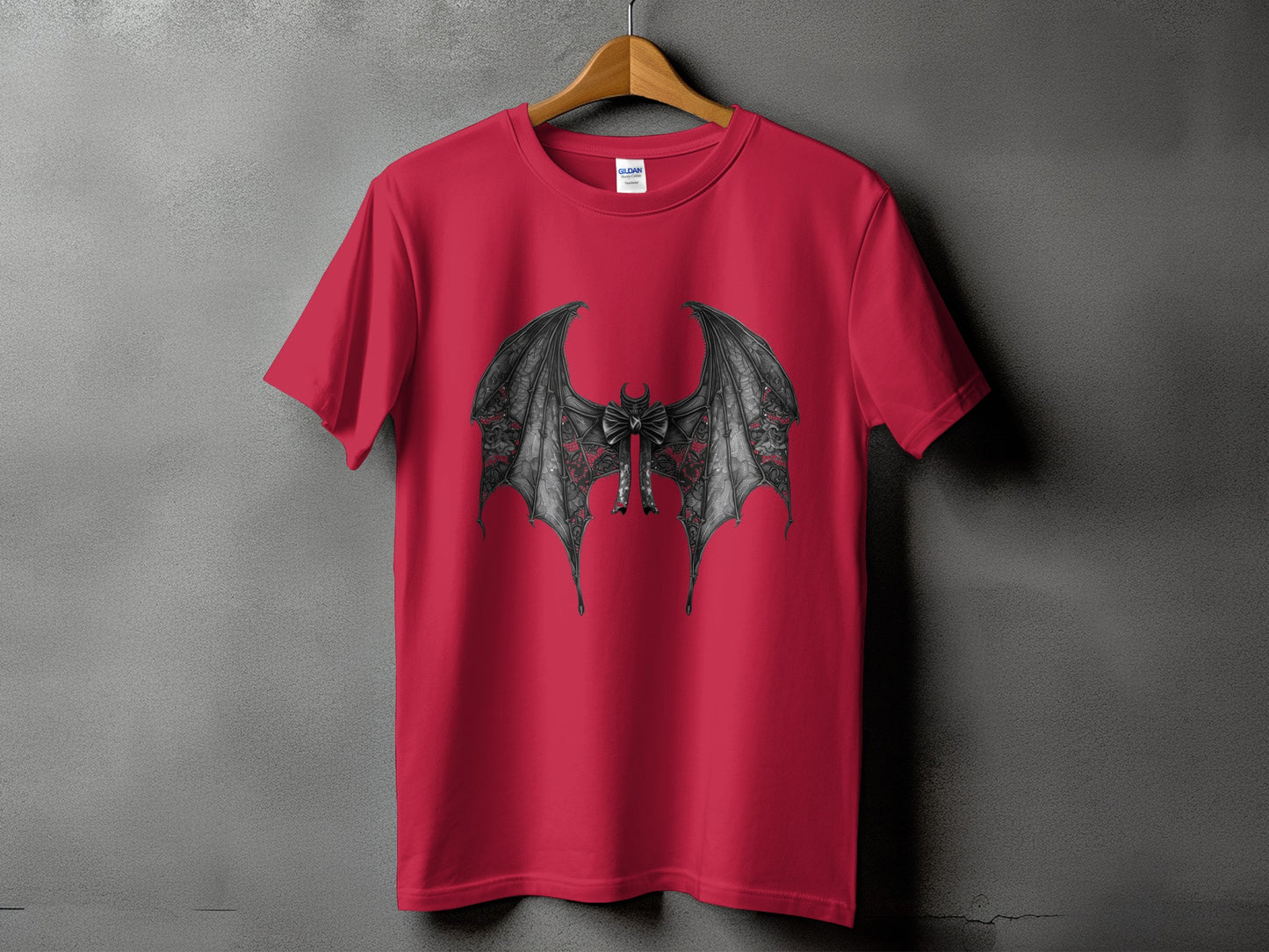 Red t-shirt with a black, ornate bat wing graphic and bow detail.