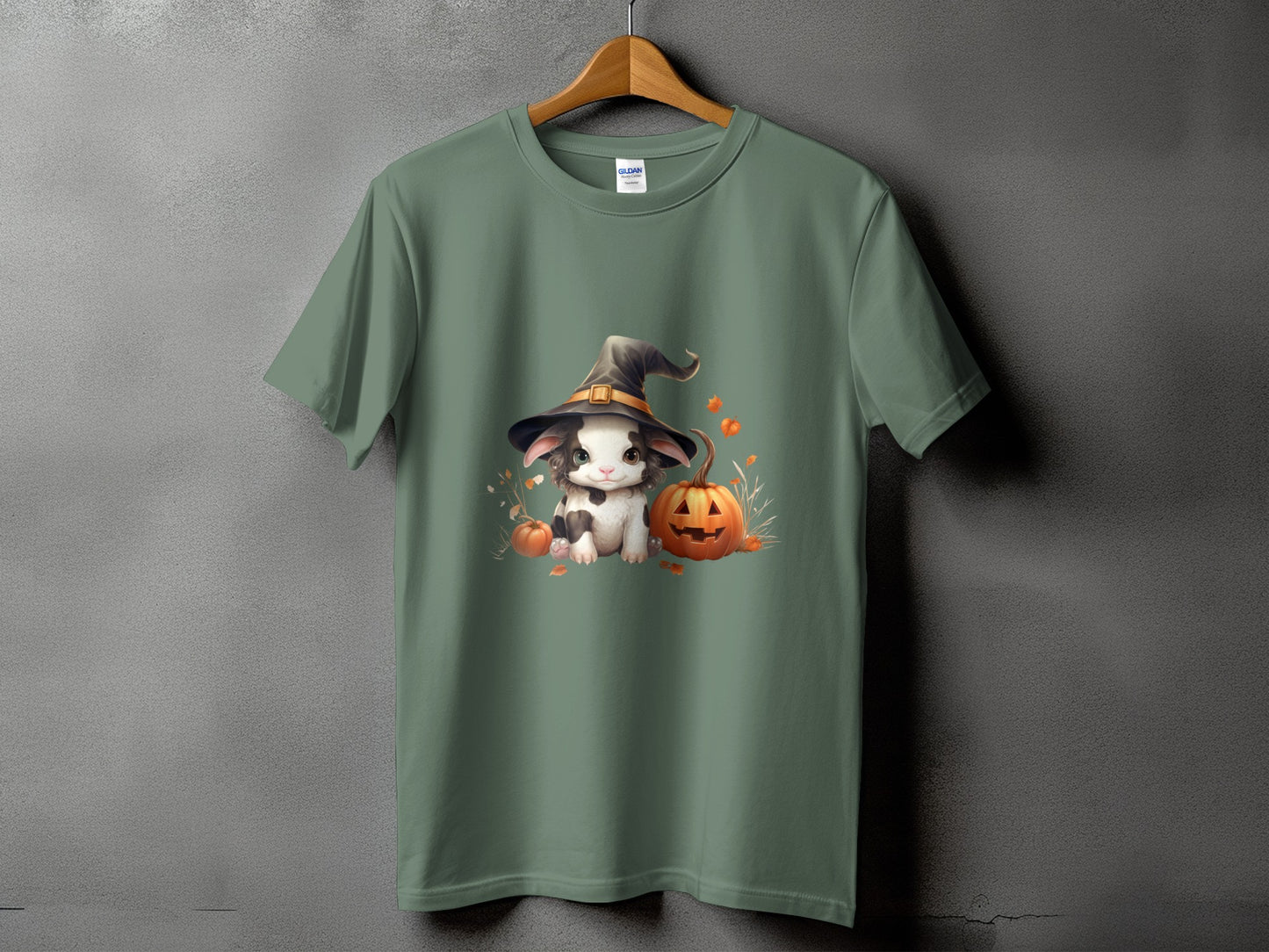 Green t-shirt with a cartoon bunny wearing a witch hat and pumpkins.