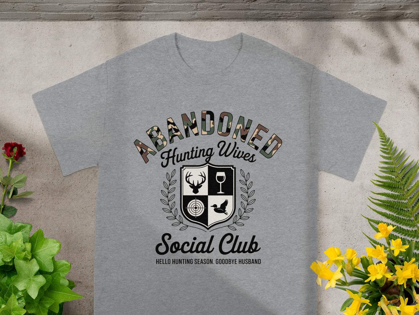 Grey t-shirt with "Abandoned Hunting Wives Social Club" graphic and tagline.