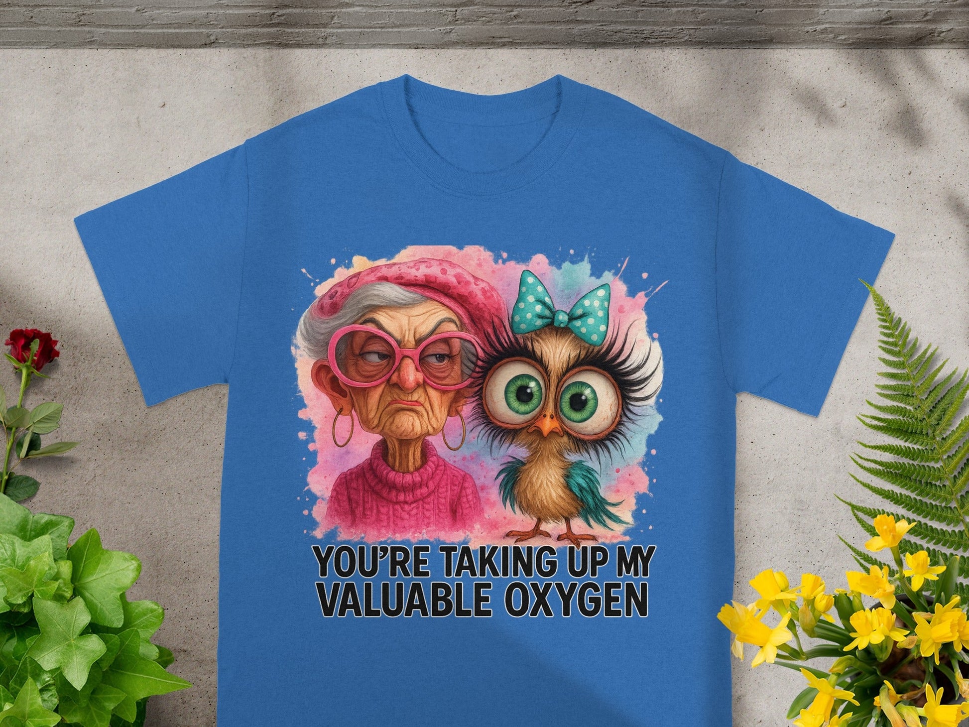 Blue t-shirt with a grumpy woman and owl graphic and text "YOU'RE TAKING UP MY VALUABLE OXYGEN".