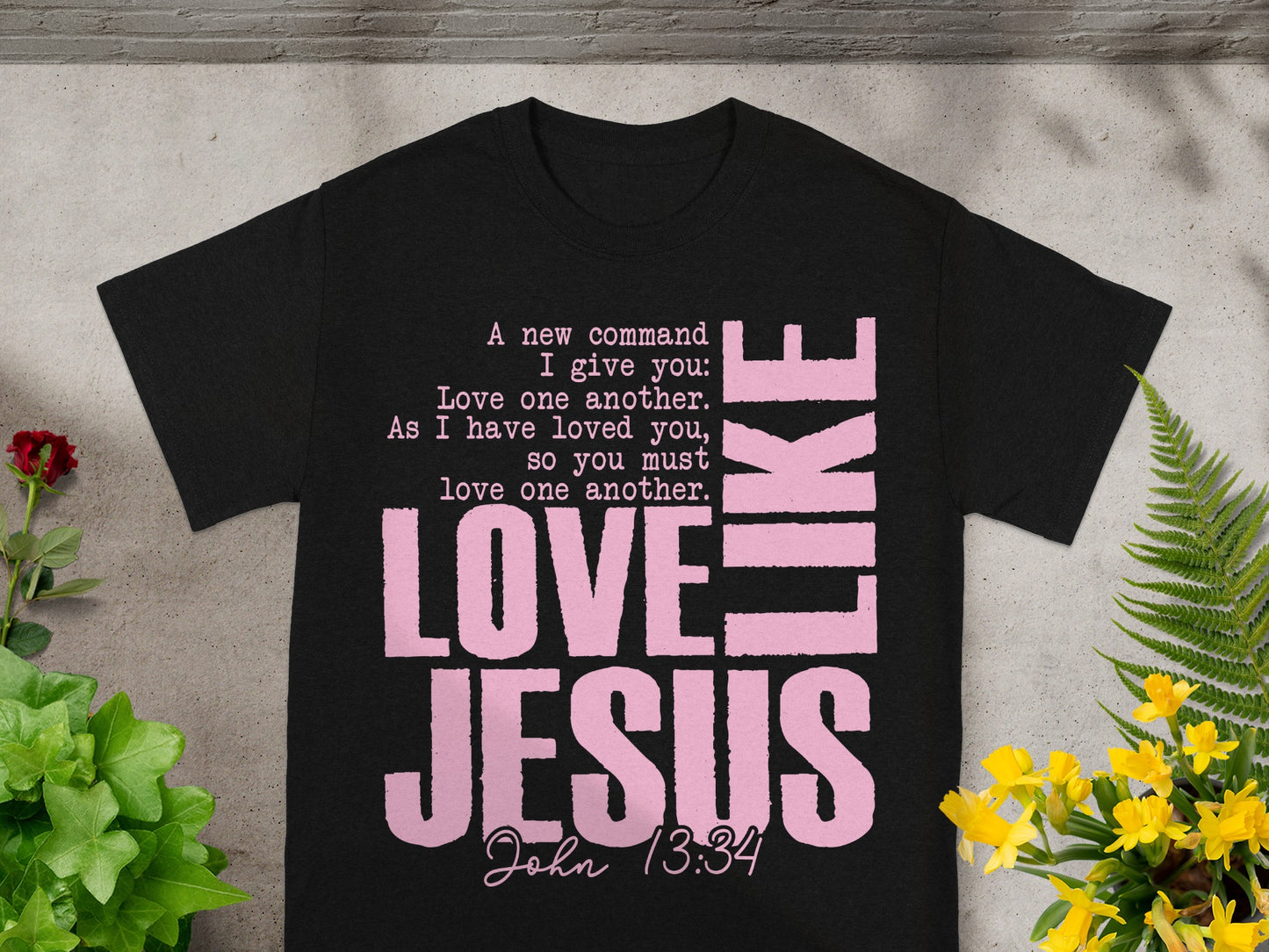 Black t-shirt with pink text reading "LOVE LIKE JESUS" and John 13:34.