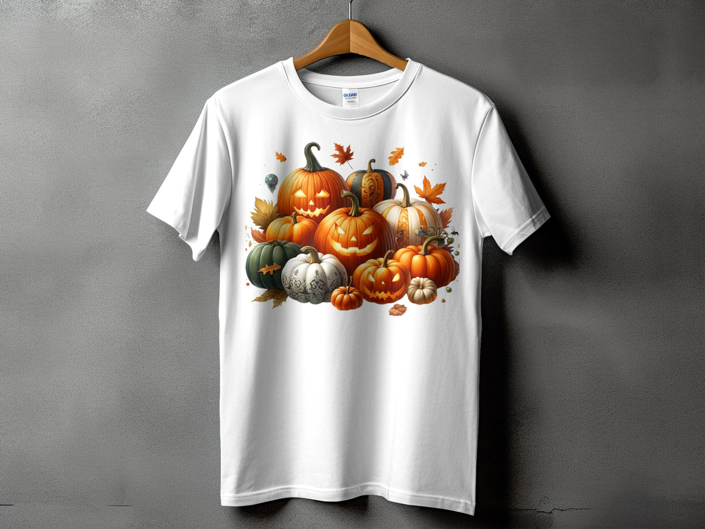 White t-shirt with Halloween pumpkins and autumn leaves graphic on the chest.