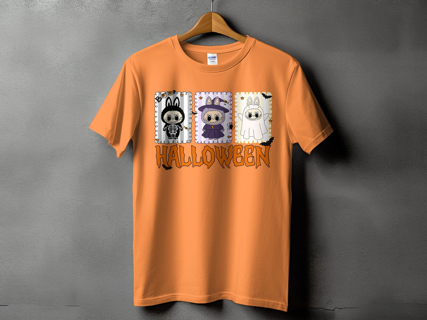 Orange t-shirt with three Halloween-themed cartoon characters and the word "HALLOWEEN".
