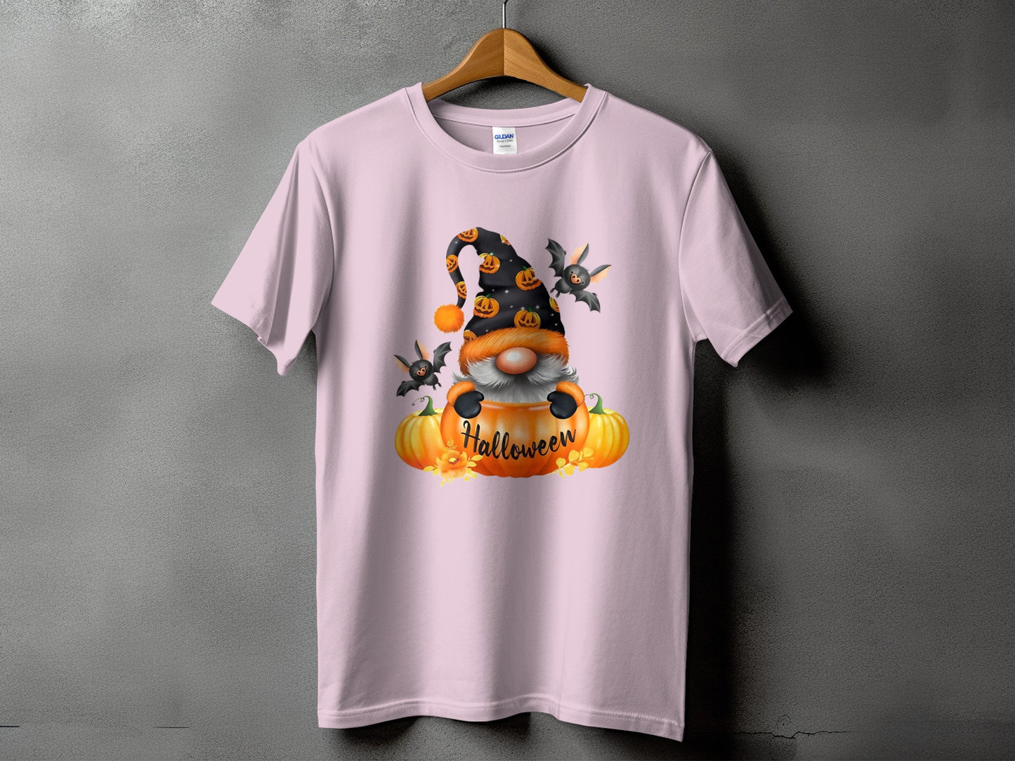 Pink t-shirt with Halloween gnome, pumpkins, bats, and "Halloween" text graphic.