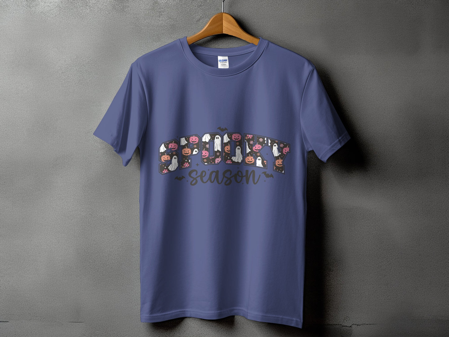Purple t-shirt with "Spooky Season" text featuring pumpkins and ghosts.