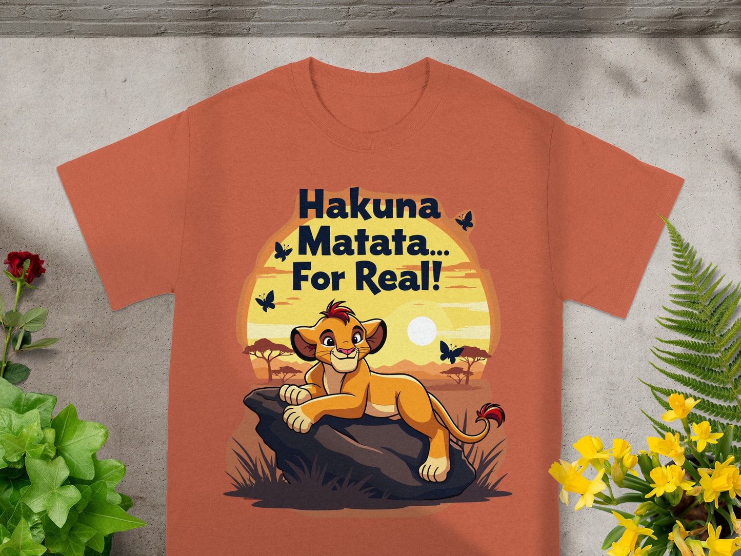 Orange t-shirt featuring Simba from The Lion King with "Hakuna Matata... For Real!" text.