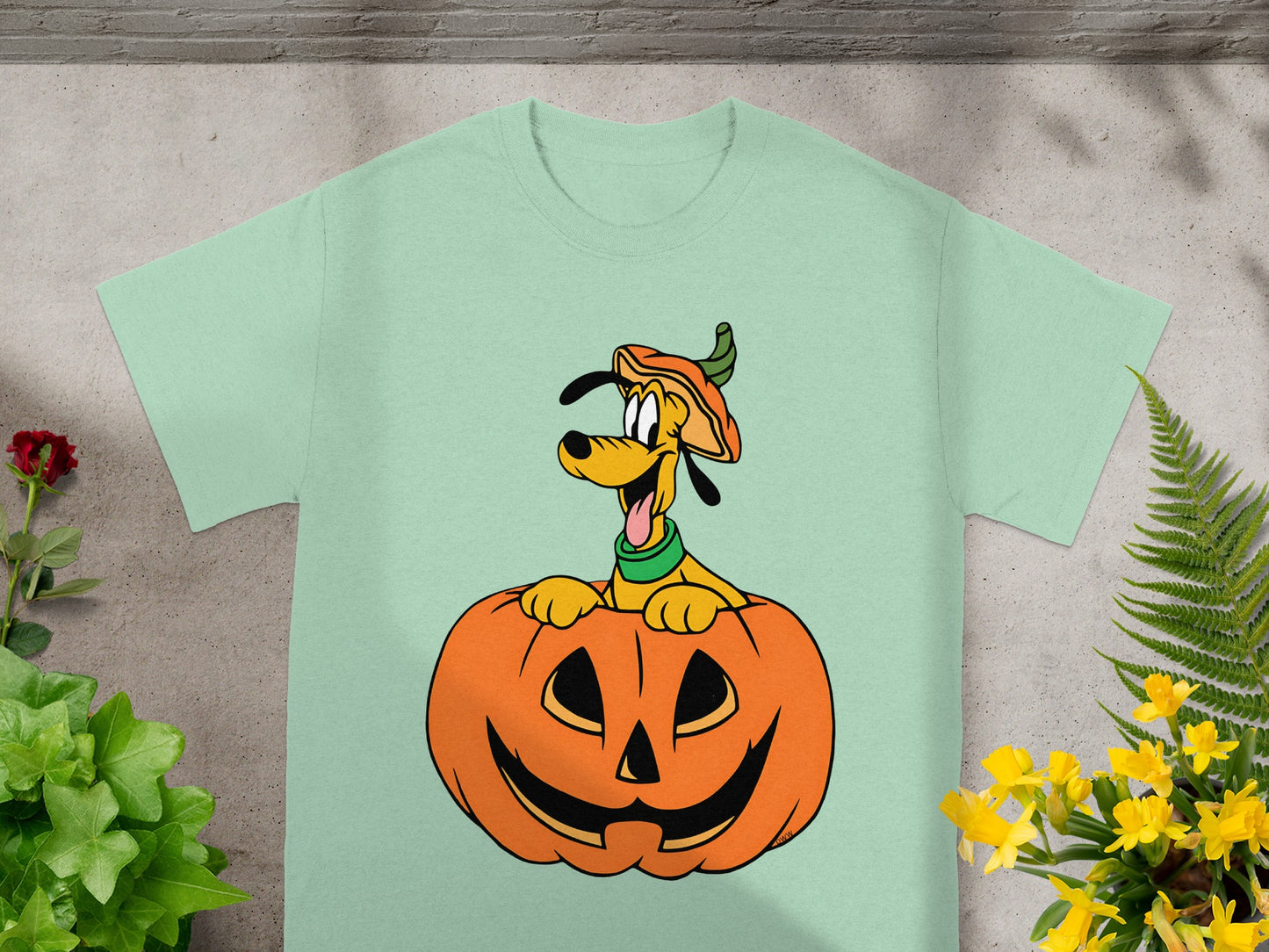 Pluto dog in a pumpkin hat and collar emerging from a jack-o'-lantern.