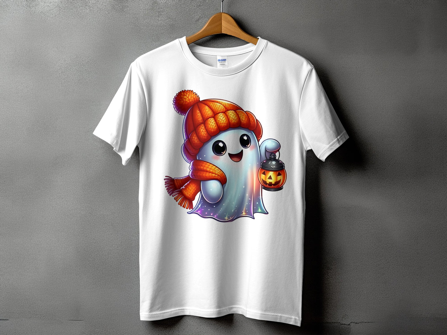 White t-shirt with a cartoon ghost wearing a hat and scarf, holding a pumpkin lantern.