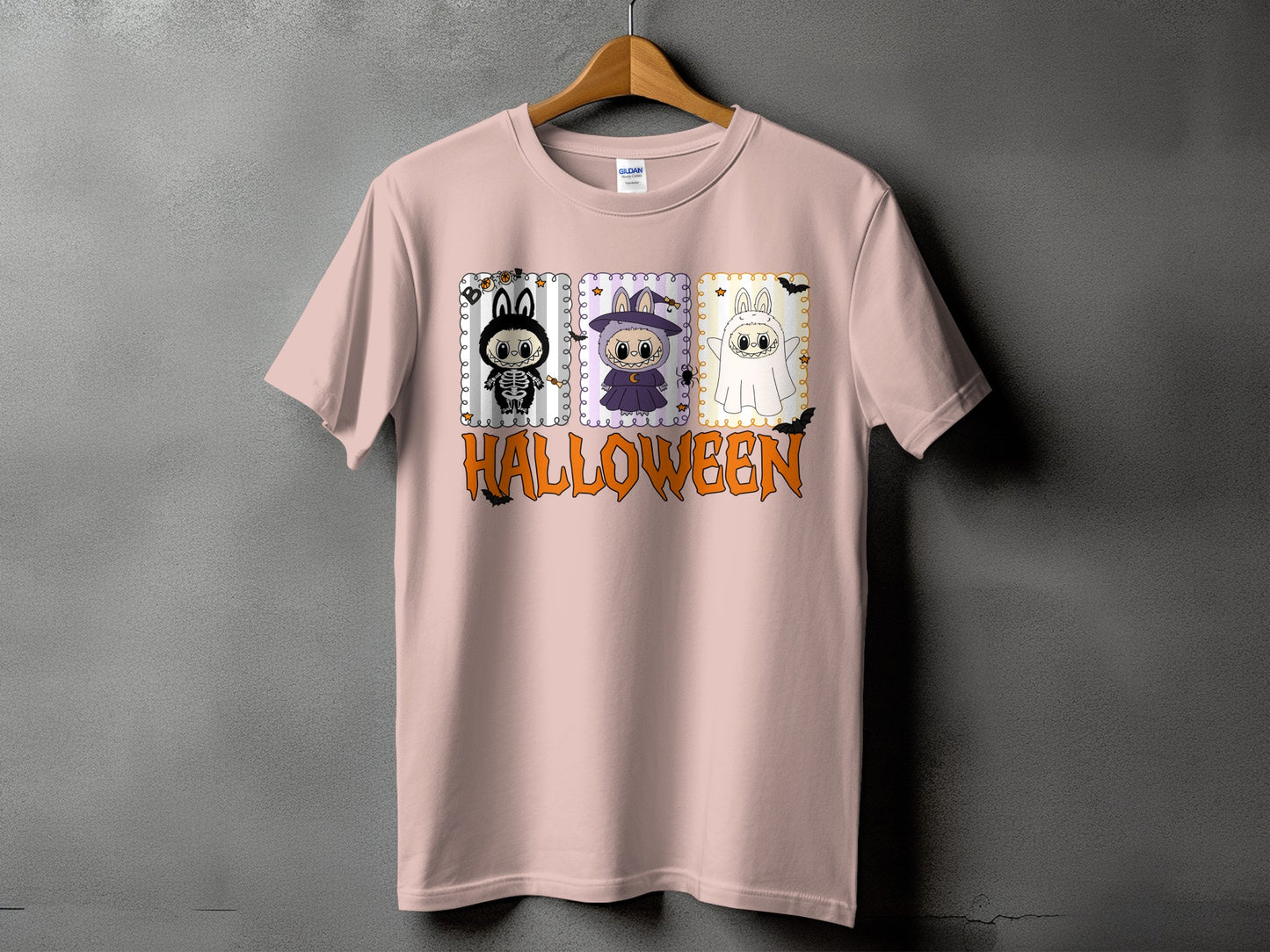 Pink t-shirt with three Halloween cartoon characters and "HALLOWEEN" text.