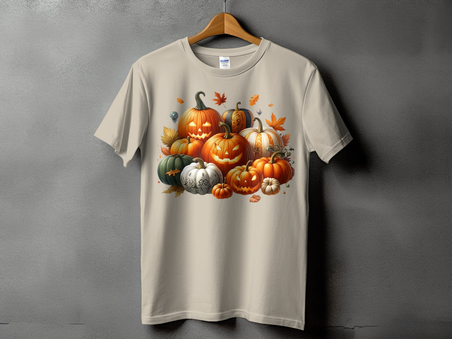 Beige t-shirt with a Halloween pumpkin and autumn leaves graphic.