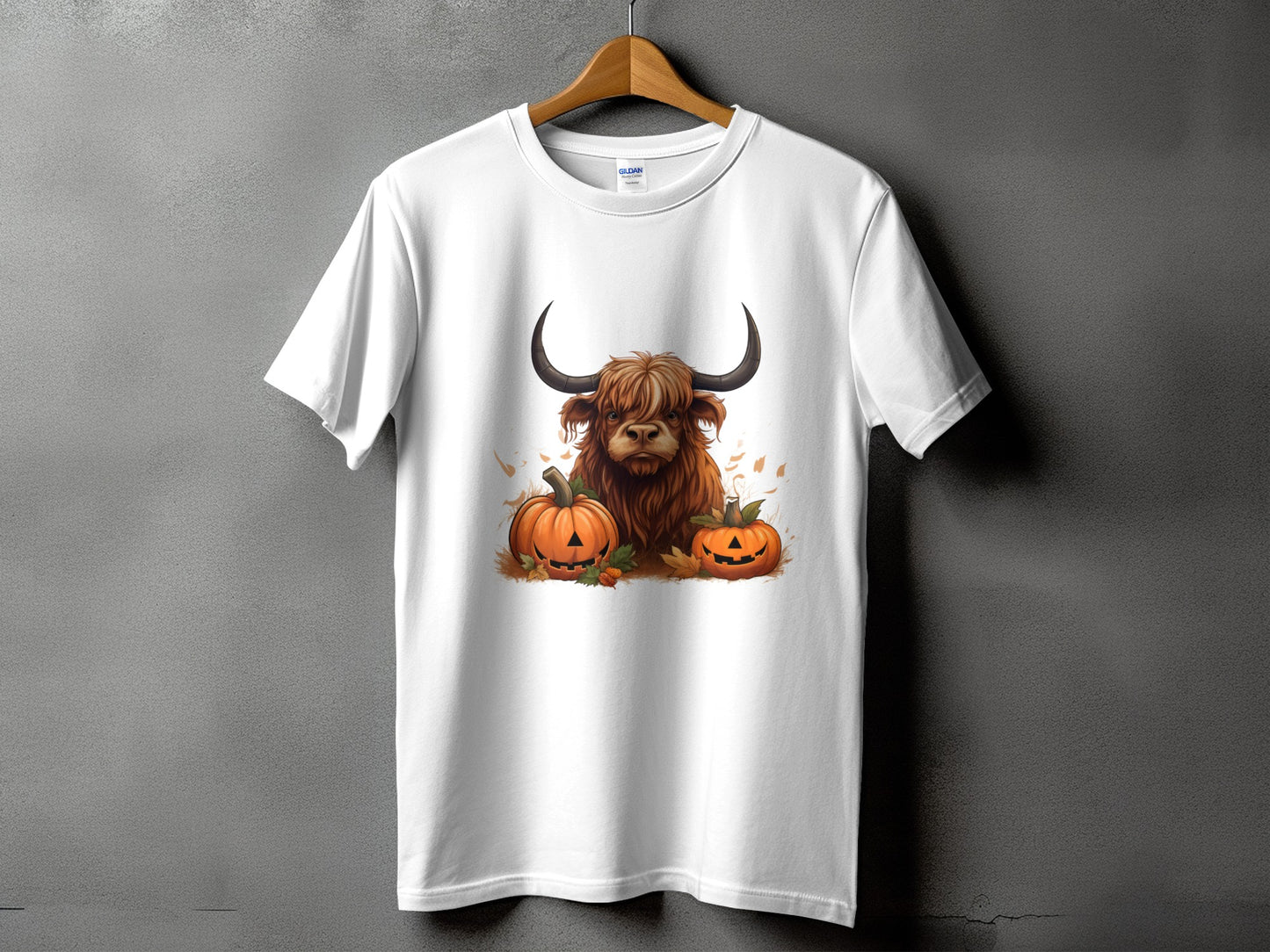 White t-shirt with a Highland cow and pumpkins graphic.