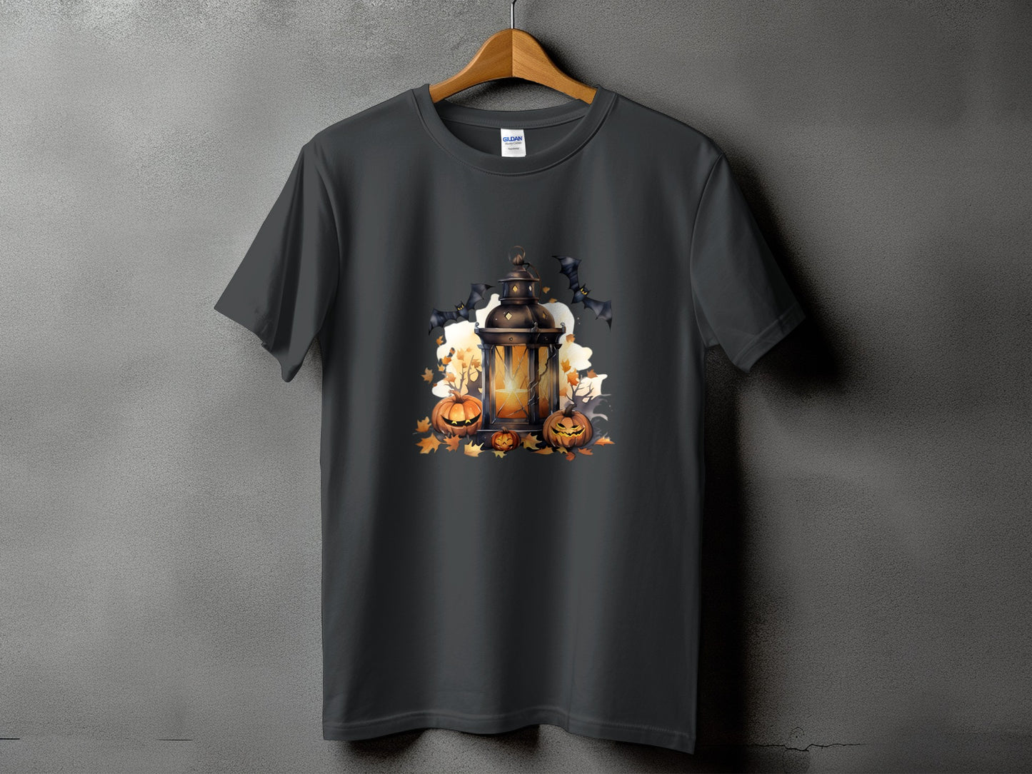 Dark t-shirt with Halloween graphic of a lantern, pumpkins, bats, and autumn leaves.