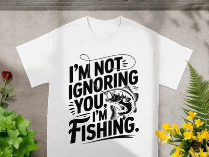 White t-shirt with "I'm not ignoring you, I'm fishing." text and fish illustration.