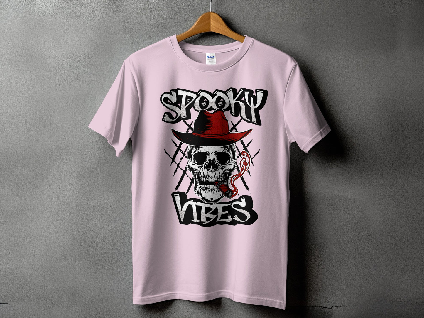 Pink t-shirt with "Spooky Vibes" text and a skull wearing a hat smoking a cigar.