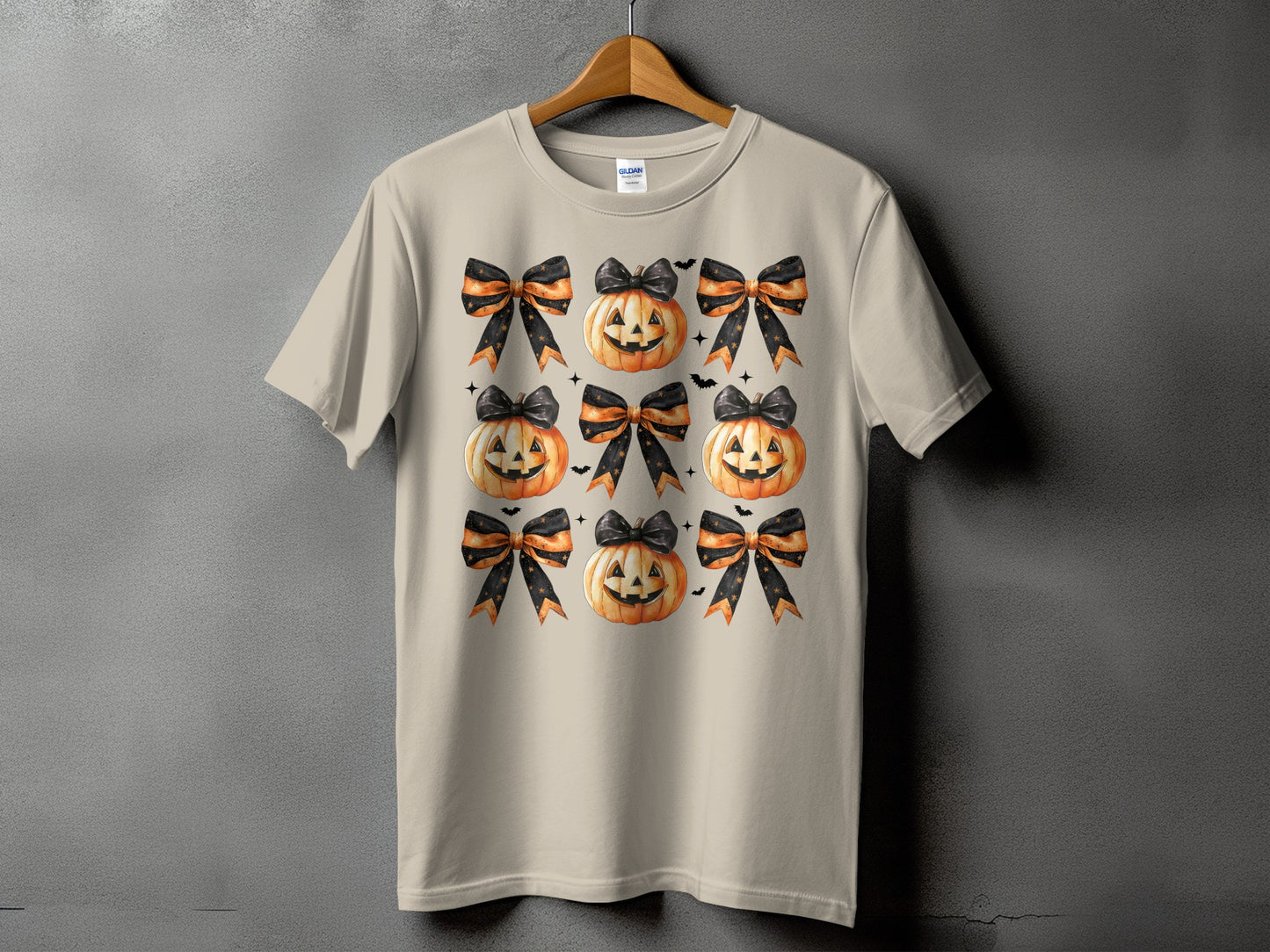 T-shirt with a repeating pattern of jack-o'-lanterns and Halloween bows.