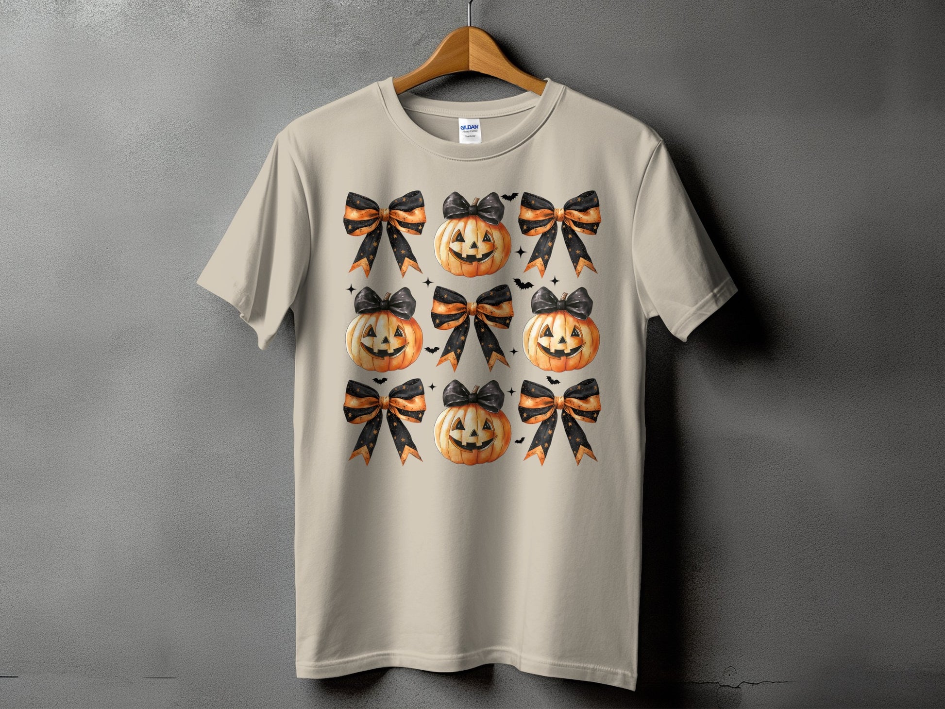 T-shirt with a repeating pattern of jack-o'-lanterns and Halloween bows.