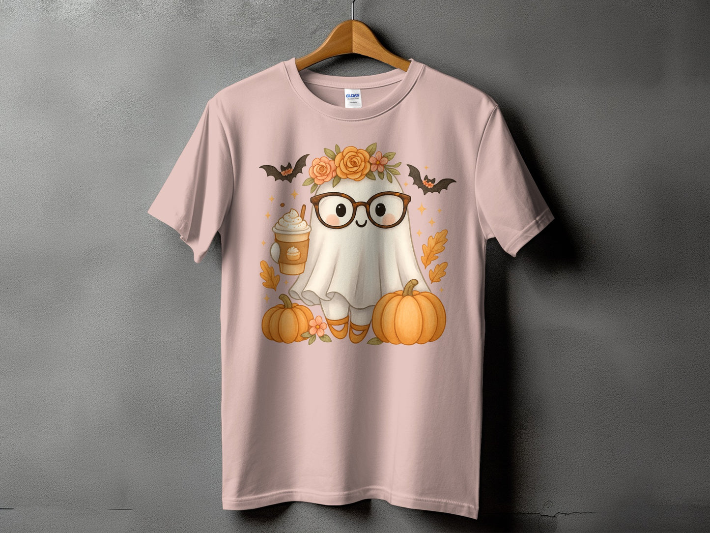 Ghost with glasses, flowers, bats, and pumpkins on a pink t-shirt.