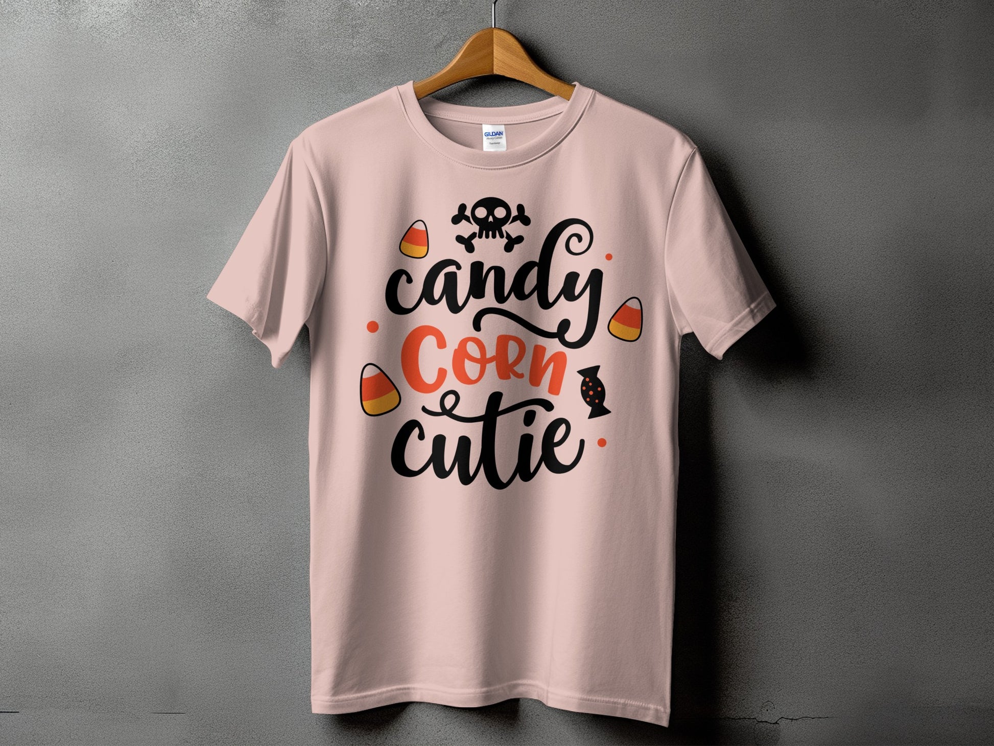 Pink t-shirt with "candy corn cutie" text, skull, and candy corn graphics.