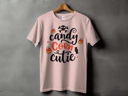 Pink t-shirt with "candy corn cutie" text, skull, and candy corn graphics.