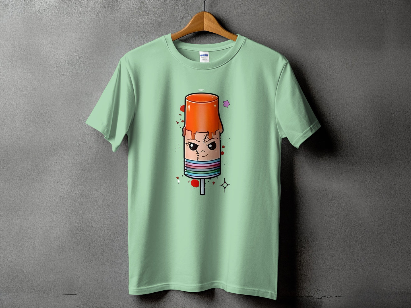 Mint green t-shirt with a cartoon popsicle with stitched eyes and mouth design.