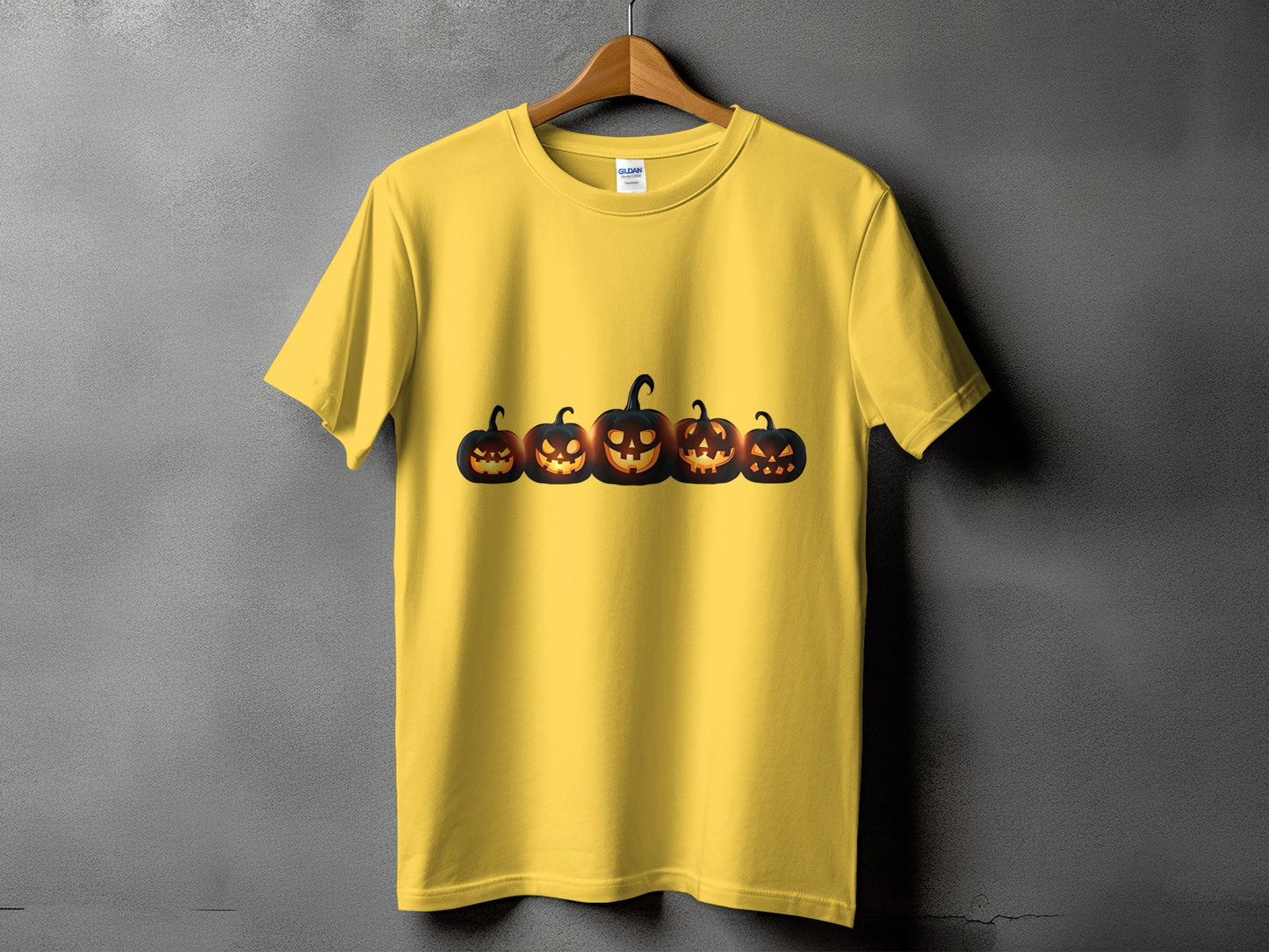 Yellow t-shirt with a row of five glowing jack-o'-lanterns across the chest.