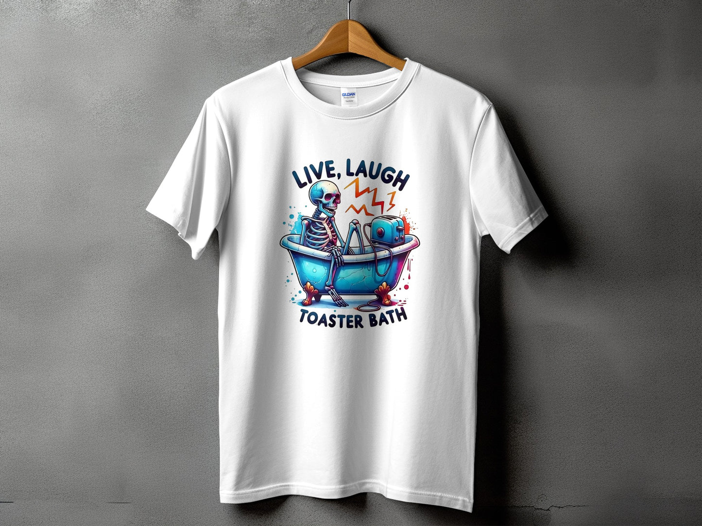 White t-shirt with a skeleton in a bathtub and a toaster, text "LIVE, LAUGH, TOASTER BATH".