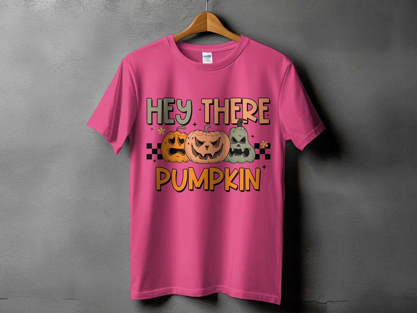 Pink t-shirt with text "HEY THERE PUMPKIN" and three jack-o'-lanterns.