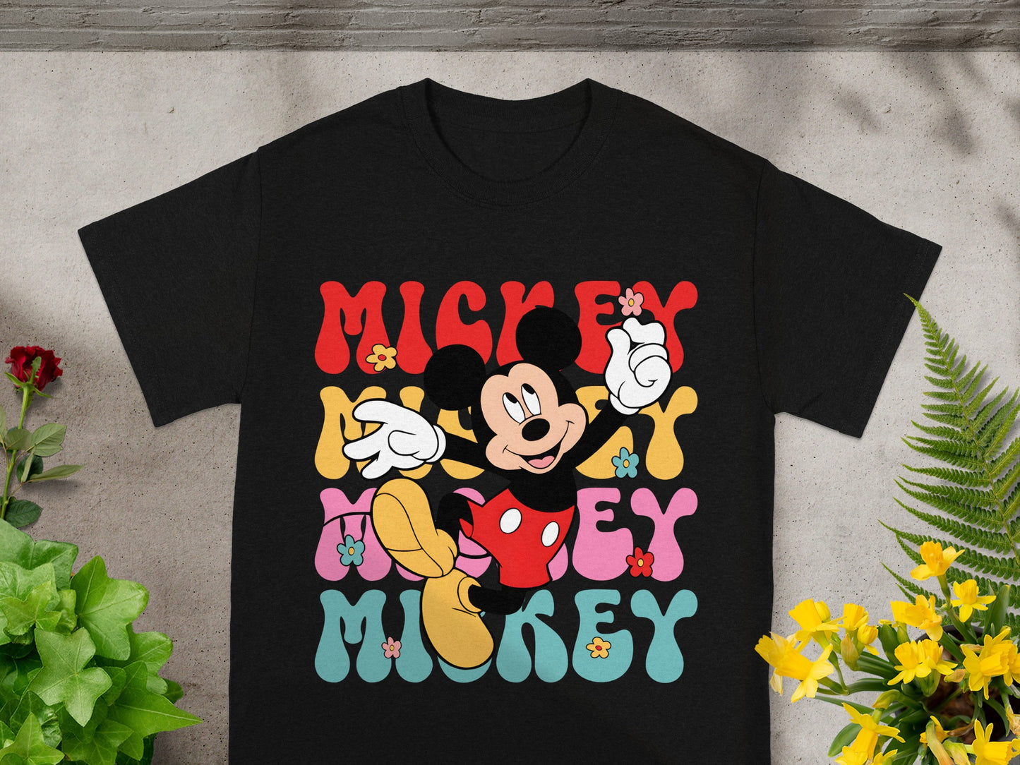 Black t-shirt with "Mickey" in colorful retro lettering and Mickey Mouse graphic.