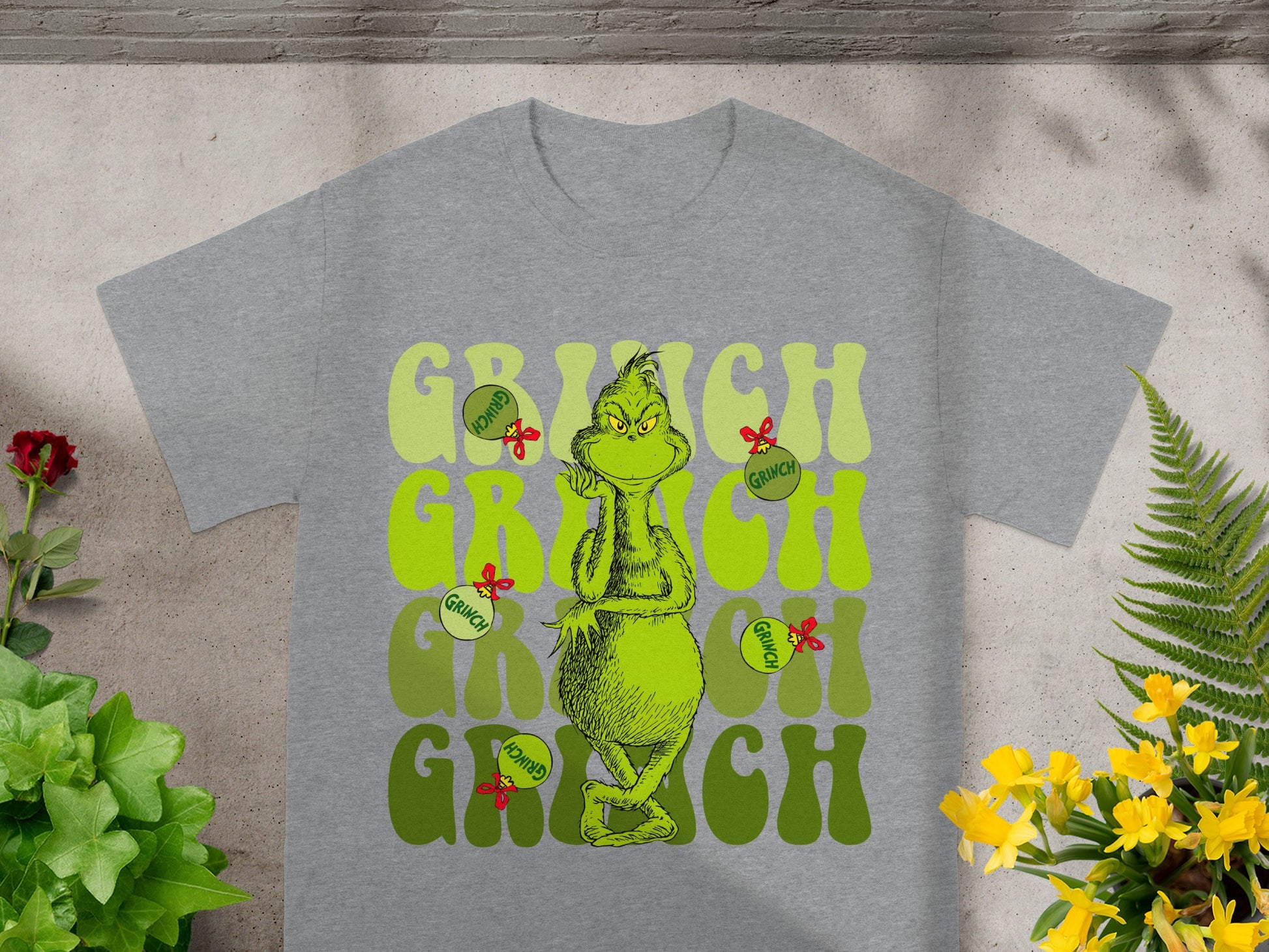 Grey t-shirt with "Grinch" text and character art.