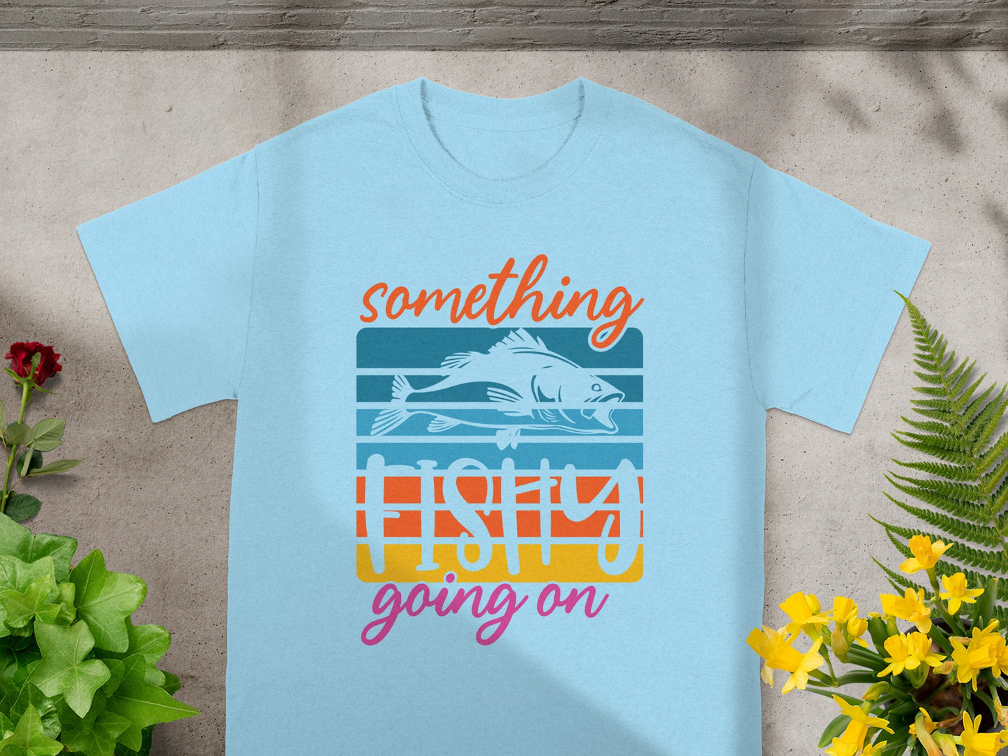 Light blue t-shirt with "Something Fishy Going On" text and a fish design.